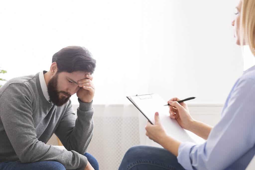 man participates in mental health counseling