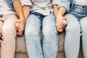 Young adults hold hands during an honesty exercise