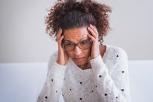 A woman looks stressed at an anxiety treatment center Portland Maine trusts as she seeks anxiety treatment Portland