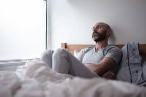 a man sits in his bed at a depression treatment center Portland Maine trusts while seeking Portland depression treatment