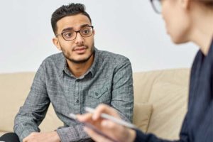 Man sits with a therapist discussing a schizophrenia treatment program in portland me