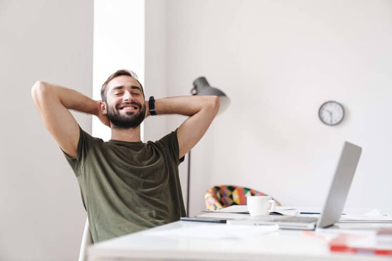 man smiling and leaning back safely celebrating recovery milestones and important milestones in recovery